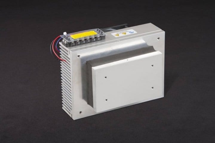 Three-quarter view of thermoelectric cold plate cooler/heater incorporating two thermoelectric modules. Cooled aluminum plate on the front, waste heat is exhausted to fins on back. Fins are fan cooled. The fan air enters on the middle back and exhausts on sides. Operates on 24 volts DC and removes 60 watts of heat at a 0°C temperature difference relative to ambient. Internal extender blocks improve the heat pumping capacity at larger temperature differences.